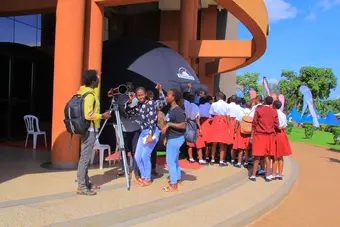 UAS outreach: school students gathered around a telescope